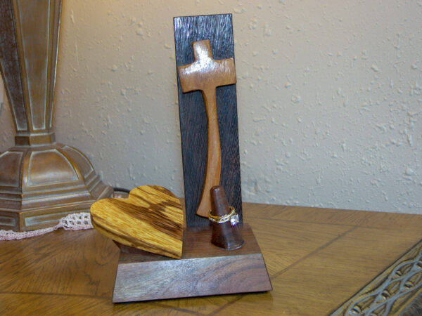 Luxury wooden wedding ring holder with cross and heart design, handmade by artisan KS Marsau at Luxe Ring Haven. Makes a unique Gift for Bride from Groom.