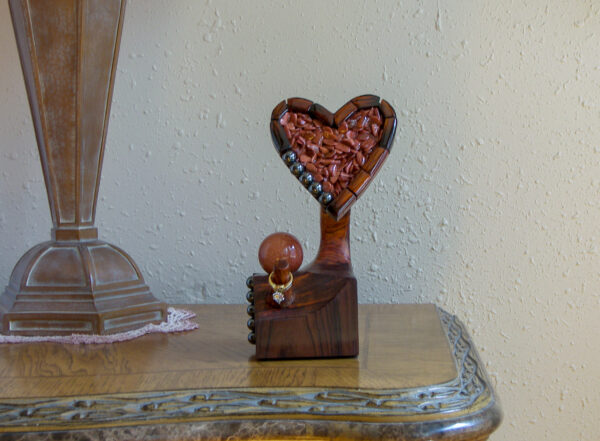 Luxury wooden wedding ring holder with cross and heart design, handmade by artisan KS Marsau at Luxe Ring Haven. Makes a unique Gift for Bride from Groom.