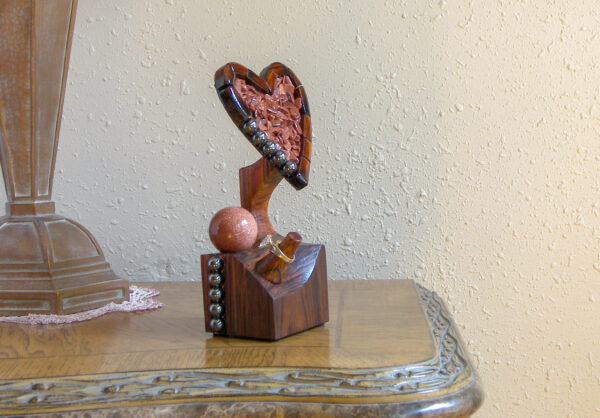 Luxury wooden wedding ring holder with cross and heart design, handmade by artisan KS Marsau at Luxe Ring Haven. Makes a unique Gift for Bride from Groom.