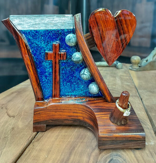 Luxury wooden wedding ring holder with cross and heart design, handmade by artisan KS Marsau at Luxe Ring Haven. Makes a unique Gift for Bride from Groom.