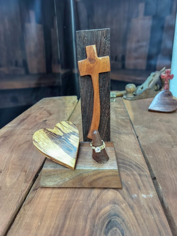 Luxury wooden wedding ring holder with cross and heart design, handmade by artisan KS Marsau at Luxe Ring Haven. Makes a unique Gift for Bride from Groom.