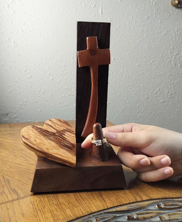 Luxury wooden wedding ring holder with cross and heart design, handmade by artisan KS Marsau at Luxe Ring Haven. Makes a unique Gift for Bride from Groom.